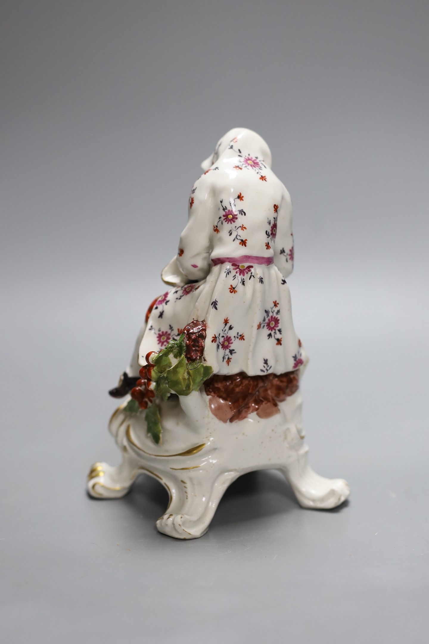 A Bow figure of Winter on a scroll moulded base painted with flowers, having an anchor dagger mark in red, 16.5 cms high
